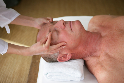 senior man having a massage in a spa center