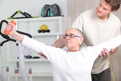 a trainer helping a senior woman doing fitness