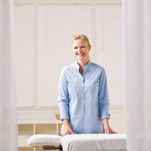 Massage therapist next to massage table