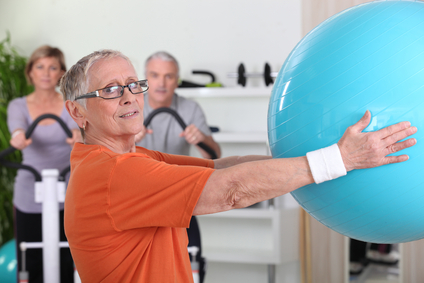 Senior woman lifting fitness balloon