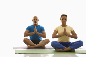 Two people practicing yoga.