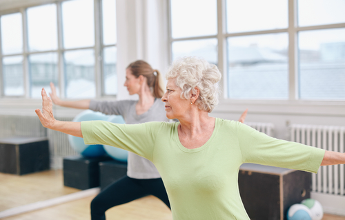 Two women doing yoga workout at gym