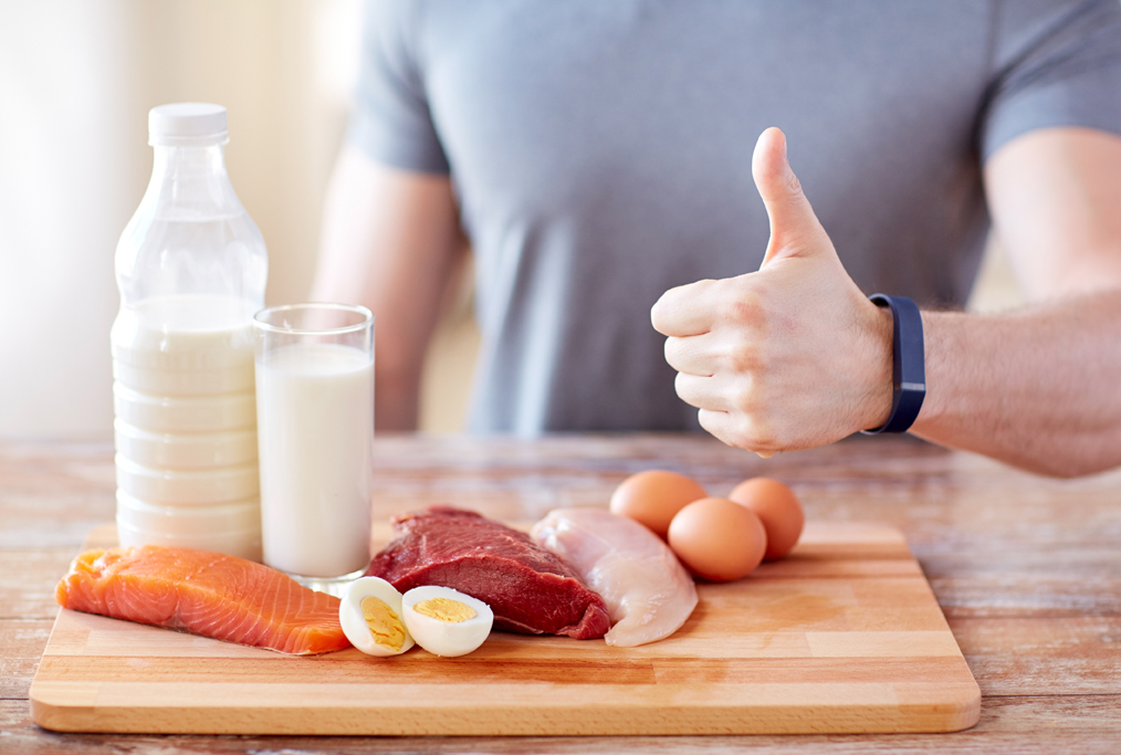 man with food  rich in protein showing thumbs up