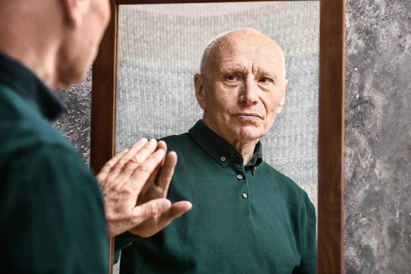 older-senior-man-looking-in-mirror
